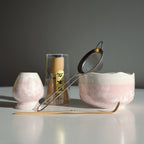 Blush Pink Matcha Set – 5 Piece Japanese Tea Ceremony Kit with front view of the ceramic bowl, metal strainer, bamboo whisk and spoon. 
